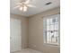 Simple bedroom with ceiling fan and window at 3669 White Sands Way, Suwanee, GA 30024