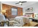 Spacious bedroom with a king-size bed and an exposed brick accent wall at 40 Daniel Se St # 6, Atlanta, GA 30312