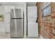 Modern laundry room with stainless steel refrigerator and stackable washer/dryer at 40 Daniel Se St # 6, Atlanta, GA 30312