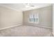 Bright bedroom with carpeted floor, ceiling fan, and window shutters at 4720 Cliffside Ct, Marietta, GA 30067