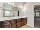 Double vanity bathroom with dark wood cabinets and large mirror at 654 Ocean Ave, Canton, GA 30114