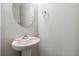 Simple powder room with pedestal sink and oval mirror at 654 Ocean Ave, Canton, GA 30114