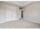 Large bedroom featuring carpeted floors and double doors at 654 Ocean Ave, Canton, GA 30114