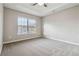 Well-lit bedroom with carpeted floor and ceiling fan at 654 Ocean Ave, Canton, GA 30114