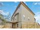 Tan house exterior with a deck and fenced backyard at 654 Ocean Ave, Canton, GA 30114