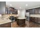 Modern kitchen with granite island, stainless steel appliances, and dark wood cabinets at 654 Ocean Ave, Canton, GA 30114