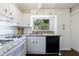 Updated kitchen with white cabinets, granite counters, and modern appliances at 101 Ardmore Nw Pl # 3, Atlanta, GA 30309