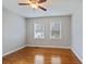 Bedroom featuring hardwood floors, two windows, and neutral walls at 1995 Benson Se Ave, Smyrna, GA 30080