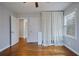 Bedroom with hardwood floors, closet with white curtains, and neutral colored walls at 1995 Benson Se Ave, Smyrna, GA 30080