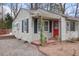 Inviting front entrance with a bright red door, flowering plants, and classic exterior at 1995 Benson Se Ave, Smyrna, GA 30080