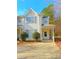 Charming two-story townhome with covered porch and landscaping at 6691 Sunset Hills Blvd, Rex, GA 30273
