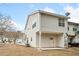 Tan house with a small patio and satellite dish at 6691 Sunset Hills Blvd, Rex, GA 30273