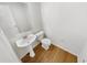 Small bathroom with pedestal sink and wood flooring at 1535 Valley Club Dr, Lawrenceville, GA 30044