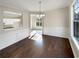 Bright dining room with hardwood floors and view into kitchen at 1535 Valley Club Dr, Lawrenceville, GA 30044