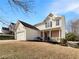 Two-story house with white siding, brick accents, and a double-car garage at 1535 Valley Club Dr, Lawrenceville, GA 30044