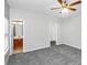 This bedroom features neutral carpet, access to a walk-in closet and connecting bathroom at 1580 Mary George Nw Ave, Atlanta, GA 30318