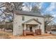 Charming two-story home with covered front porch, brick accents, and neutral siding at 1580 Mary George Nw Ave, Atlanta, GA 30318