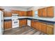 Well-lit kitchen featuring wood cabinets, laminate countertops, and vinyl flooring at 1580 Mary George Nw Ave, Atlanta, GA 30318