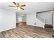 This living room features wood-look flooring, a ceiling fan, and staircase at 1580 Mary George Nw Ave, Atlanta, GA 30318