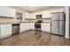 Modern kitchen with stainless steel appliances and wood-look flooring at 4074 Yeager Rd, Douglasville, GA 30135