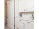 Bright laundry room with white cabinets and quartz countertops at 437 Great Pine Way, Woodstock, GA 30188