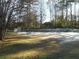 Large backyard with trees and a partially snow-covered lawn at 610 Erins Way, Mcdonough, GA 30253