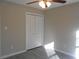 Bright bedroom with double door closet and ceiling fan at 610 Erins Way, Mcdonough, GA 30253