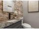 Elegant powder room with stone tile and modern vanity at 1102 Fountain Sw Dr, Atlanta, GA 30314