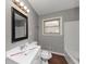 Bright bathroom featuring wood flooring, vanity, toilet and shower-tub combo at 1963 Shannon Ridge Ct, Decatur, GA 30032