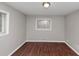This bedroom features hardwood floors, neutral paint, and a window for natural light at 1963 Shannon Ridge Ct, Decatur, GA 30032