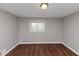 This bedroom features hardwood floors, neutral paint, and a window for natural light at 1963 Shannon Ridge Ct, Decatur, GA 30032