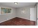 Bedroom featuring two windows and hardwood floors at 1963 Shannon Ridge Ct, Decatur, GA 30032