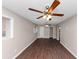 A spacious room with wood-look flooring, a ceiling fan, and multiple windows at 1963 Shannon Ridge Ct, Decatur, GA 30032