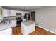 Bright kitchen features white cabinets, stainless steel appliances, an island, and wood flooring at 1963 Shannon Ridge Ct, Decatur, GA 30032
