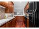 Modern kitchen with black appliances and wood cabinets at 3101 Howell Mill Nw Rd # 206, Atlanta, GA 30327