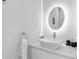 Modern bathroom with a sleek vanity, round mirror, and geometric patterned wall at 85 Boulevard Ne, Atlanta, GA 30312