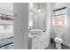 Clean bathroom with a toilet, vanity, and window at 85 Boulevard Ne, Atlanta, GA 30312