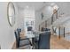 Modern dining area with glass table, black chairs, and open staircase at 85 Boulevard Ne, Atlanta, GA 30312