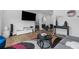 Open living room with hardwood floors, stylish furniture, and a large TV at 85 Boulevard Ne, Atlanta, GA 30312
