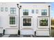 Modern rear exterior of townhome with white siding, black windows, and attached garage at 85 Boulevard Ne, Atlanta, GA 30312