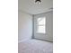 Bright bedroom with carpeted floor and window at 11821 Rizvan Pl, Covington, GA 30014