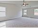 Spacious main bedroom with carpeted floors and ceiling fan at 11821 Rizvan Pl, Covington, GA 30014