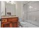 Bathroom with granite vanity, wood cabinet, and glass shower at 2832 Springbluff Ln, Buford, GA 30519