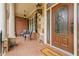 Brick porch with inviting seating area and a decorative front door at 2832 Springbluff Ln, Buford, GA 30519