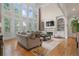 Two story Gathering room with hardwood floors, built-in shelving, and a fireplace at 2832 Springbluff Ln, Buford, GA 30519