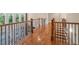 Elegant hardwood hallway with wrought iron railings and large windows at 2832 Springbluff Ln, Buford, GA 30519