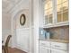 White kitchen with granite countertops and glass-front cabinets at 2832 Springbluff Ln, Buford, GA 30519