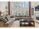Sunlit living room featuring a cozy sectional sofa and fireplace at 2832 Springbluff Ln, Buford, GA 30519