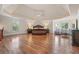 Large main bedroom with hardwood floors, sitting area, and tray ceiling at 2832 Springbluff Ln, Buford, GA 30519