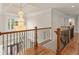 Elegant upper hall with chandelier and hardwood floors at 2832 Springbluff Ln, Buford, GA 30519